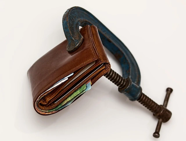 immagine di un portafogli stretto da una morsa che rappresenta il budget limitato nella nello Scrivere la Sceneggiatura di un Romanzo